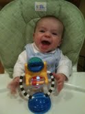 3 month old Gavin playing with Sassy Illumination Station suctioned cup to booster seat tray